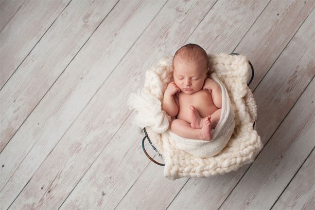 Baby in a Basket and Wood Floor